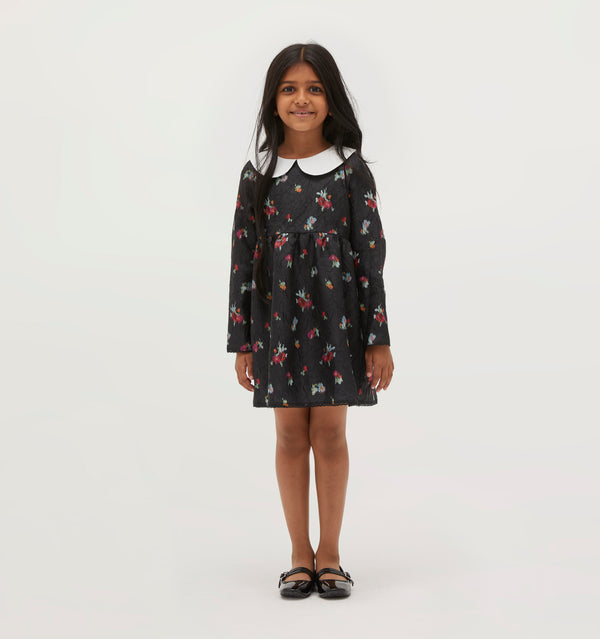Amelia wears a 5/6Y in the Black Ikat Floral color: Black Ikat Floral Crushed Taffeta