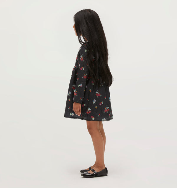 Amelia wears a 5/6Y in the Black Ikat Floral color: Black Ikat Floral Crushed Taffeta