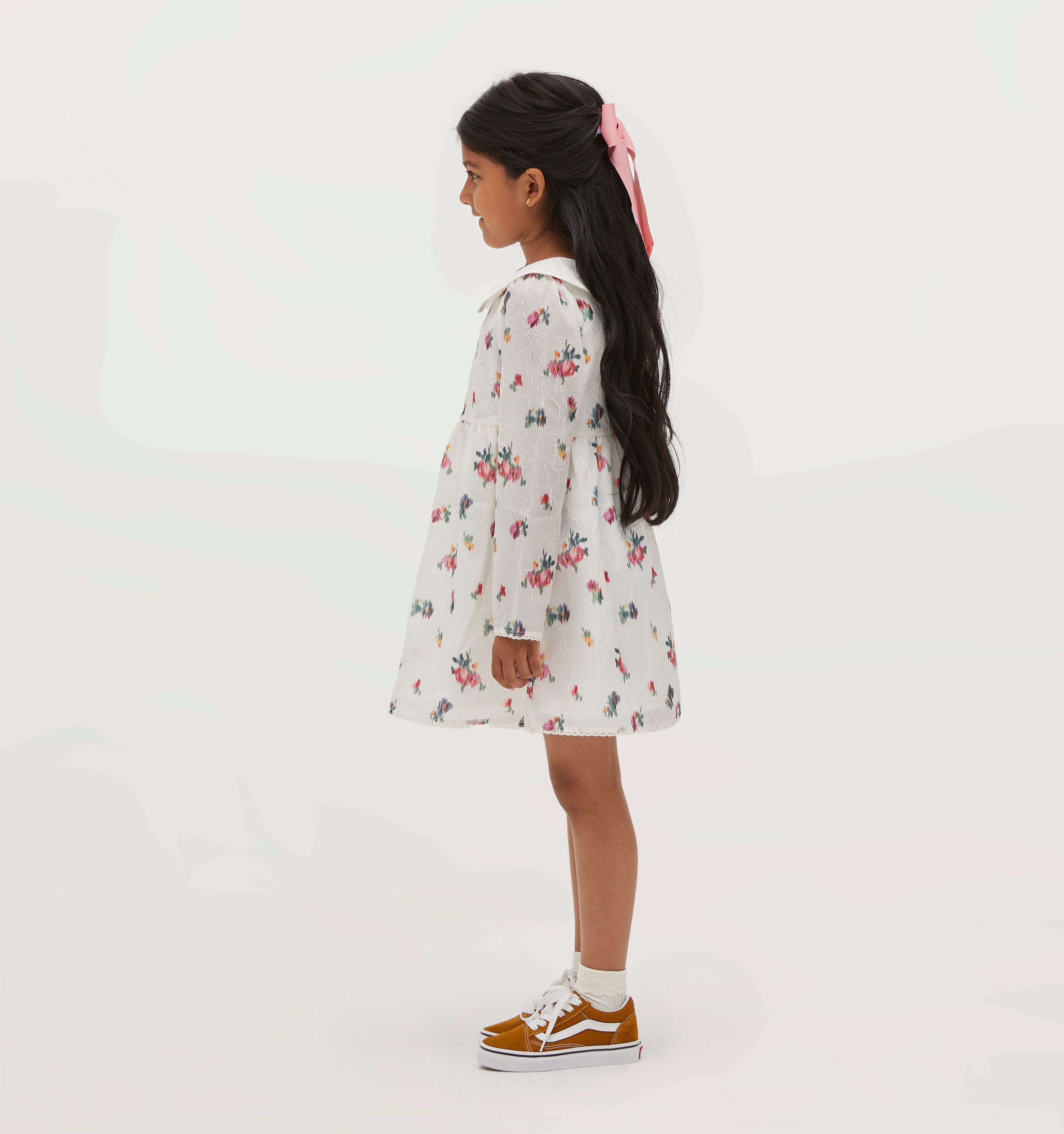 Amelia wears a 5/6Y in the Ivory Ikat Floral color: Ivory Ikat Floral Crushed Taffeta