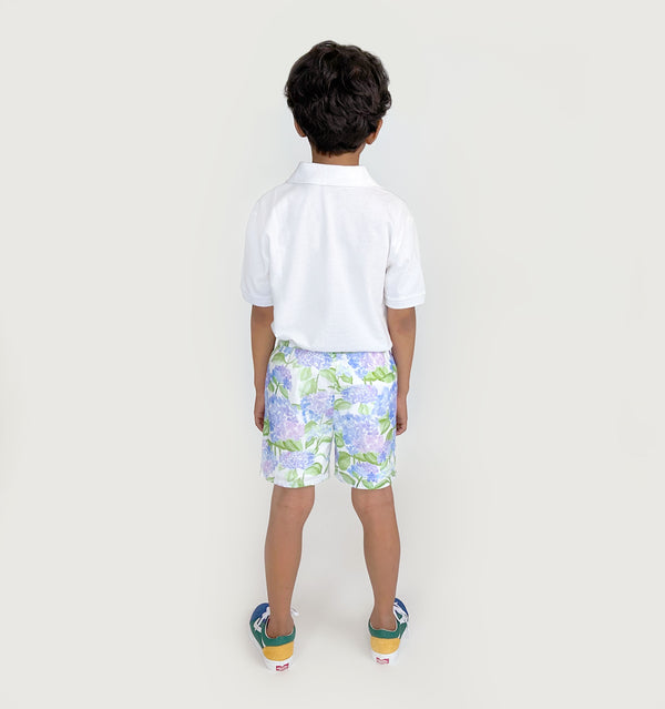 Carter wears a size 7-8Y in the Blue Hydrangea Seersucker color: Blue Hydrangea Seersucker