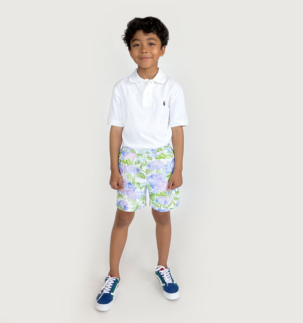 Carter wears a size 7-8Y in the Blue Hydrangea Seersucker color: Blue Hydrangea Seersucker