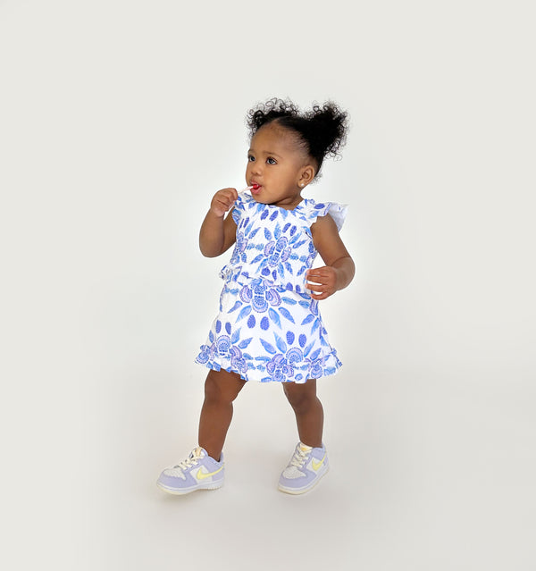Ka’lani wears a size 12-18M in the Blue Shell Mosaic Linen color: Blue Shell Mosaic Linen