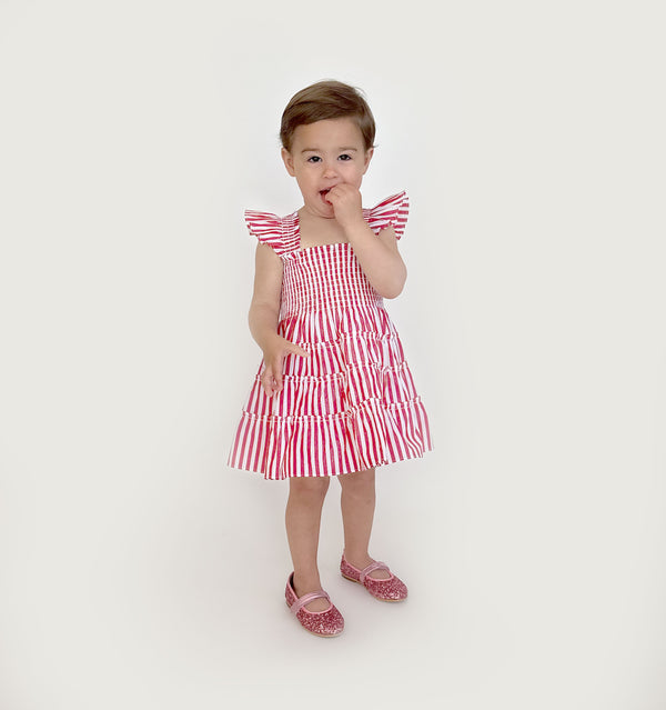 Sienna wears a size 2Y in the Cherry Stripe color: Cherry Stripe
