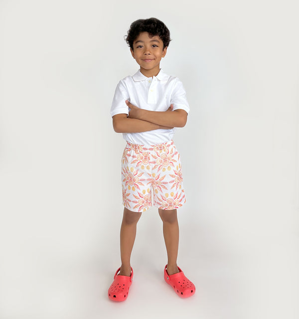 Carter wears a size 7-8Y in the Orange Shell Mosaic Seersucker color: Orange Shell Mosaic Seersucker