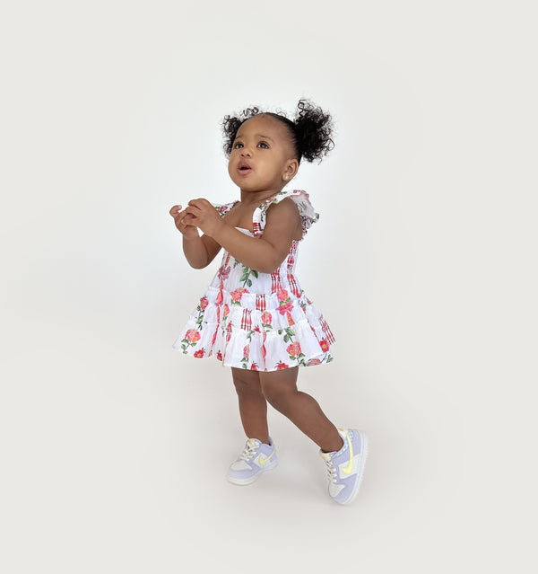 Ka’lani wears a size 12-18M in the Red Shell Vine Stripe color: Red Shell Vine Stripe Cotton
