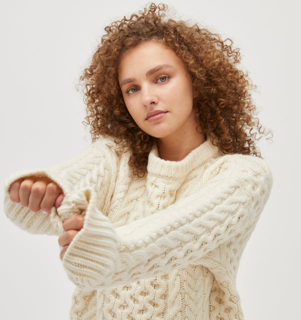 Gabriella is 5' 9.5" and wears a size XS in the Ivory Fisherman Knit color: Ivory Fisherman Knit